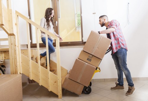 Professional movers handling a flat removal in a South East London building